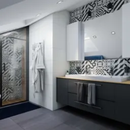 Nowoczesna łazienka na poddaszu z kabiną prysznicową z wzorzystą szybą, czarną armaturą, umywalką nablatową i geometrycznymi płytkami na ścianie.