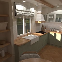 MZ InteriorDesign - Jasna kuchnia w stylu rustykalnym z drewnianymi belkami stropowymi, zielonymi szafkami i białym zlewem pod oknem. Otwarta półka z dekoracjami po lewej stronie.