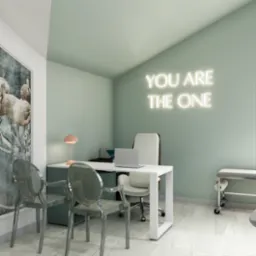 Pastelowe biuro z neonem 'YOU ARE THE ONE', biurkiem, lampką i przezroczystymi krzesłami. Na ścianie grafika z flamingami. Stonowana kolorystyka, nowoczesny minimalizm.