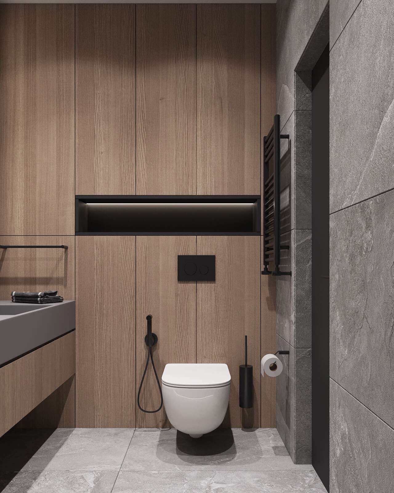 Nowoczesna łazienka z drewnianą zabudową, podwieszaną toaletą z bidetką, szarą umywalką i grzejnikiem drabinkowym na tle szarej, kamiennej ściany.