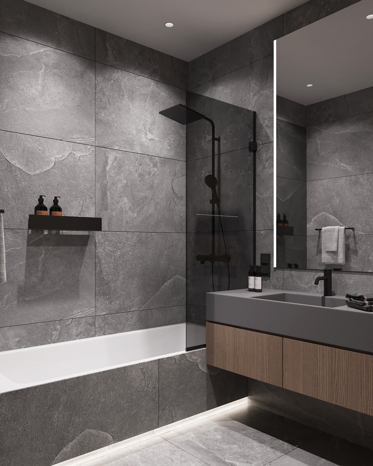 Nowoczesna łazienka z szarymi płytkami imitującymi kamień, czarną armaturą i podświetleniem LED pod wanną i szafką umywalkową.