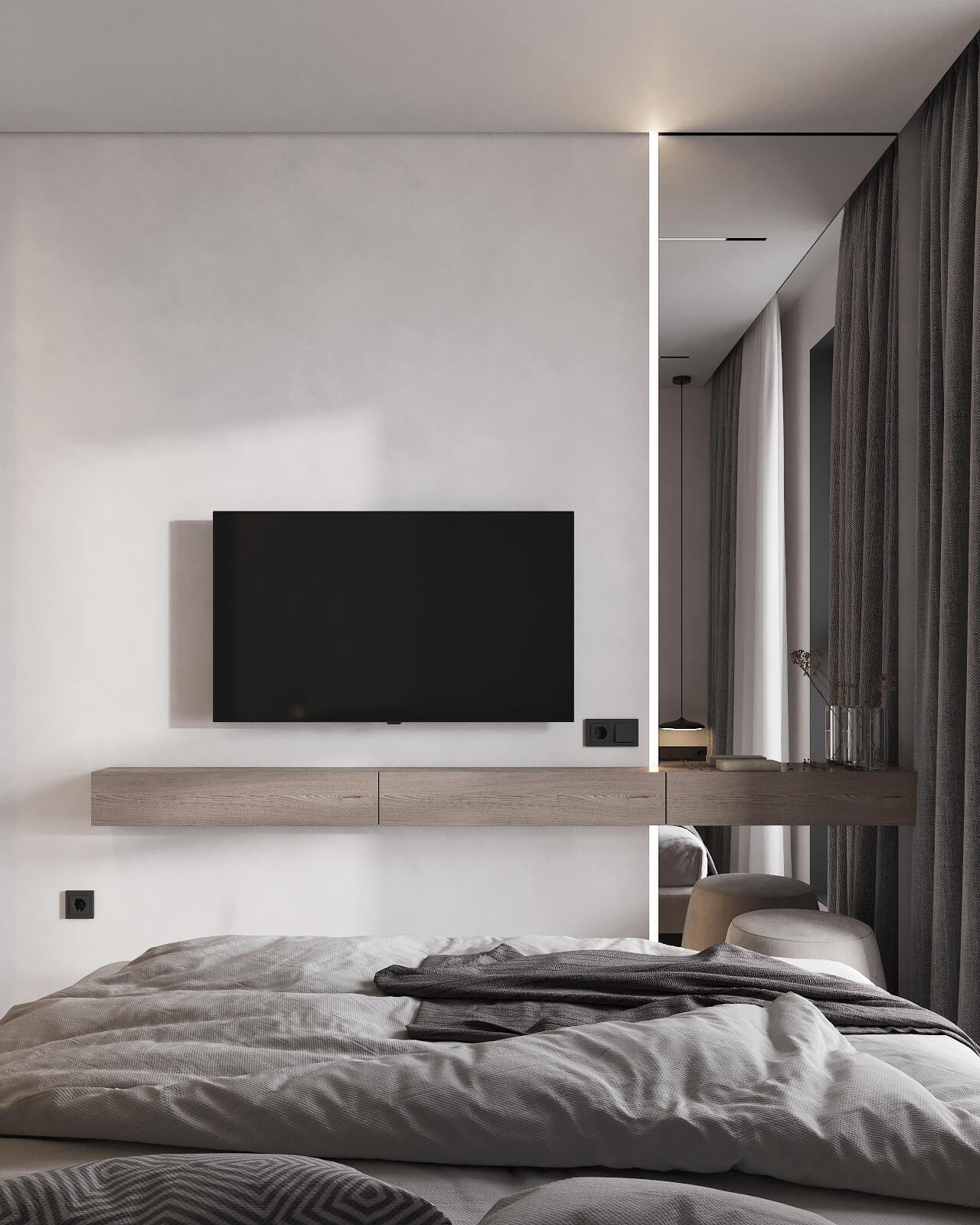 Nowoczesna sypialnia w stonowanych szarościach z telewizorem na ścianie i podświetlanym lustrem obok zasłon.