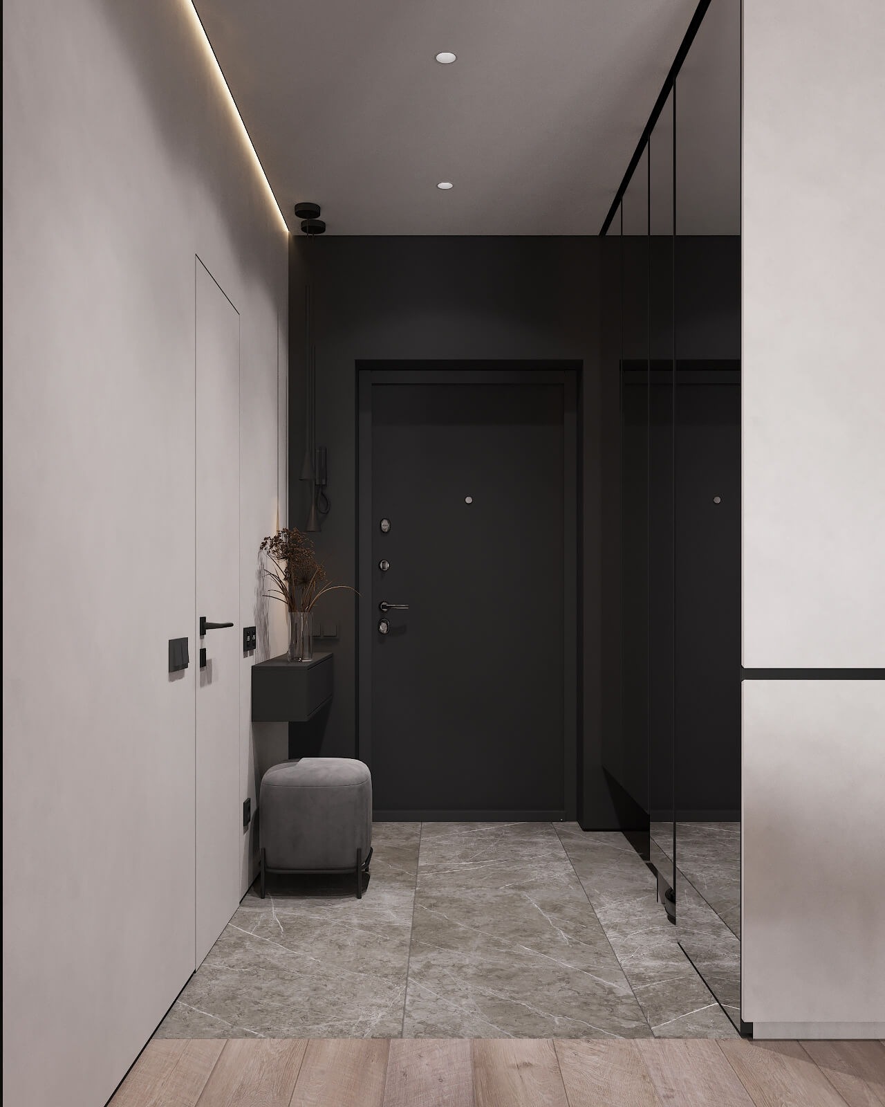 Nowoczesny przedpokój w stonowanej kolorystyce z szarą pufą, minimalistyczną konsolą z suchymi kwiatami, lustrem w czarnej ramie i drzwiami wejściowymi w kolorze antracytu.