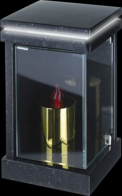 Lampa nagrobna z czarnego kamienia z przeszklonymi ściankami, wewnątrz złoty wkład na znicz z imitacją płomienia.