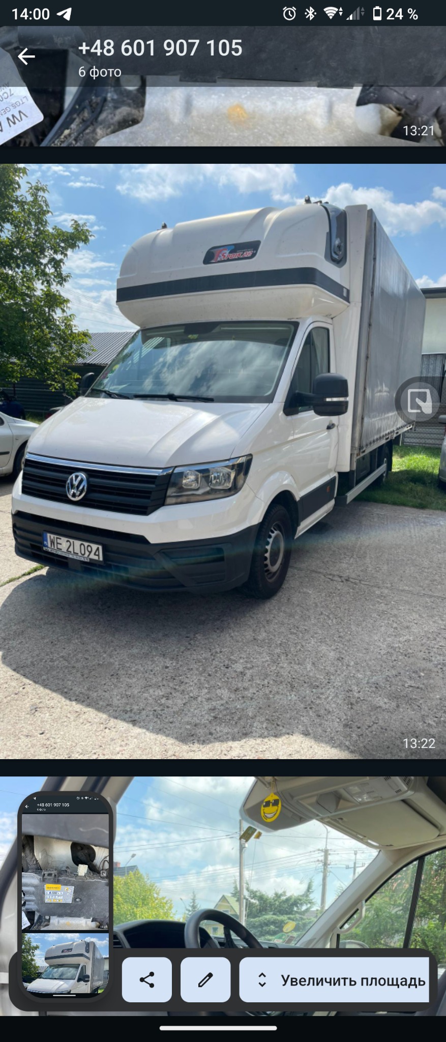 Biały samochód dostawczy Volkswagen Crafter z zabudową kontenerową typu furgon z plandeką, zaparkowany na betonowym podjeździe przed budynkiem.