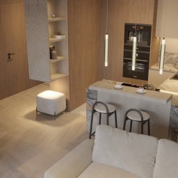 Kaolin Interiors Karolina Grzywa - Nowoczesna kuchnia z wyspą, drewniane fronty szafek, wbudowany sprzęt AGD, marmurowy blat, minimalistyczne oświetlenie i krzesła barowe.