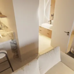 Wnętrze mieszkania z otwartą kuchnią, widok z góry na wysoki stołek barowy, blat kuchenny z marmurowym wzorem, oraz fragment łazienki z okrągłym lustrem i drewnianymi szafkami, oddzielone białymi...