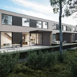 Nowoczesny budynek wielorodzinny z elewacją w odcieniach szarości, z dużymi oknami i przesuwnymi drzwiami tarasowymi, otoczony zielenią