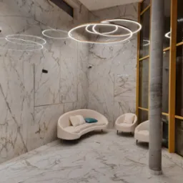 Eleganckie wnętrze holu wejściowego z marmurowymi ścianami i podłogą, oświetlone nowoczesnymi lampami w kształcie pierścieni, z kremową sofą i fotelami.