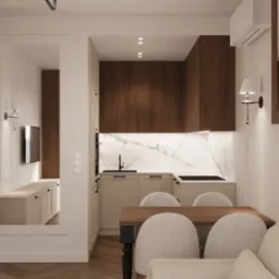 Nowoczesna aranżacja wnętrza: kuchnia z marmurowym blatem, drewniane szafki, stół z krzesłami i lustro odbijające salon z telewizorem. Ciepłe oświetlenie.