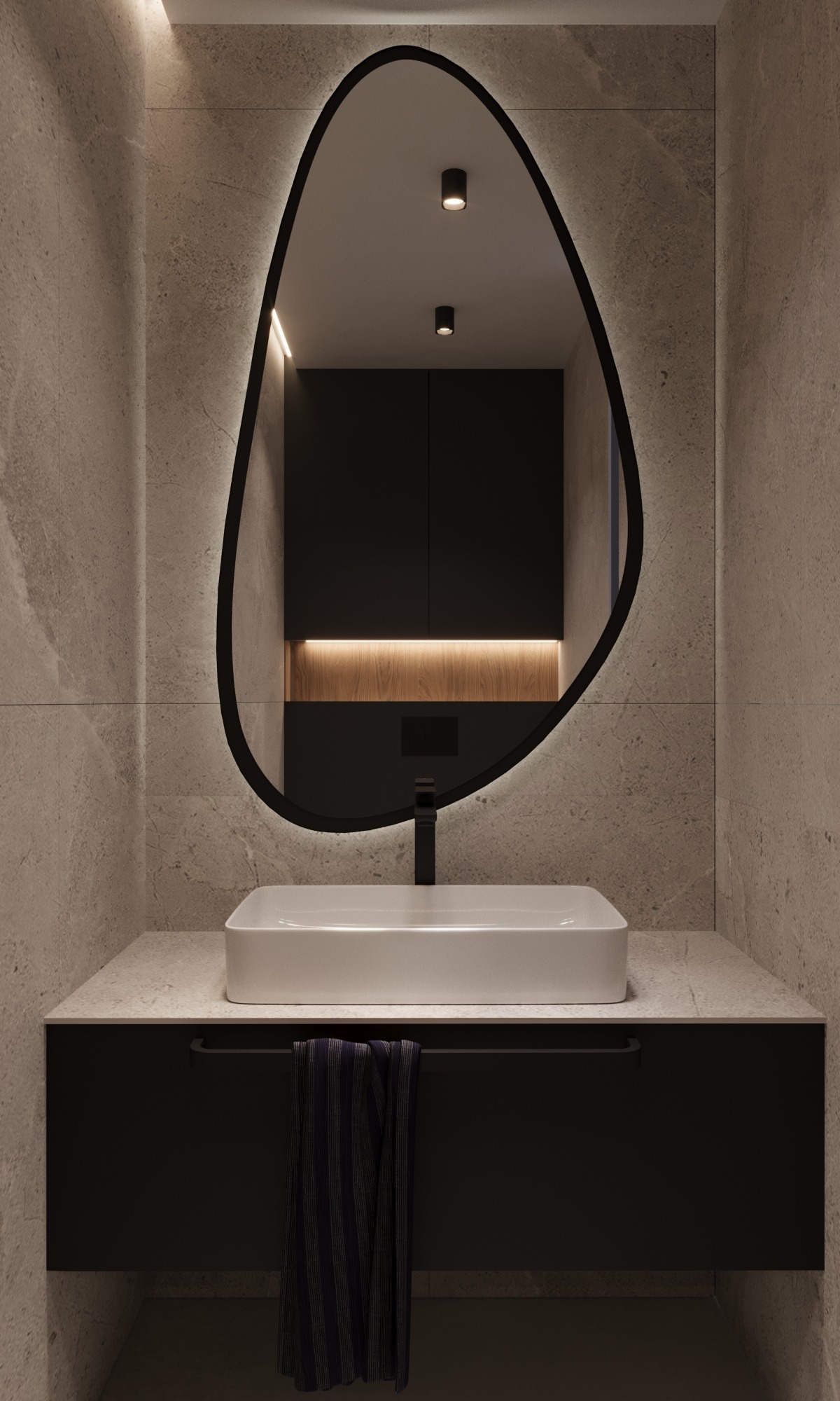 Nowoczesna łazienka: biała umywalka na czarnej szafce, podświetlane lustro o nieregularnym kształcie, szare płytki imitujące kamień. Minimalistyczny design.