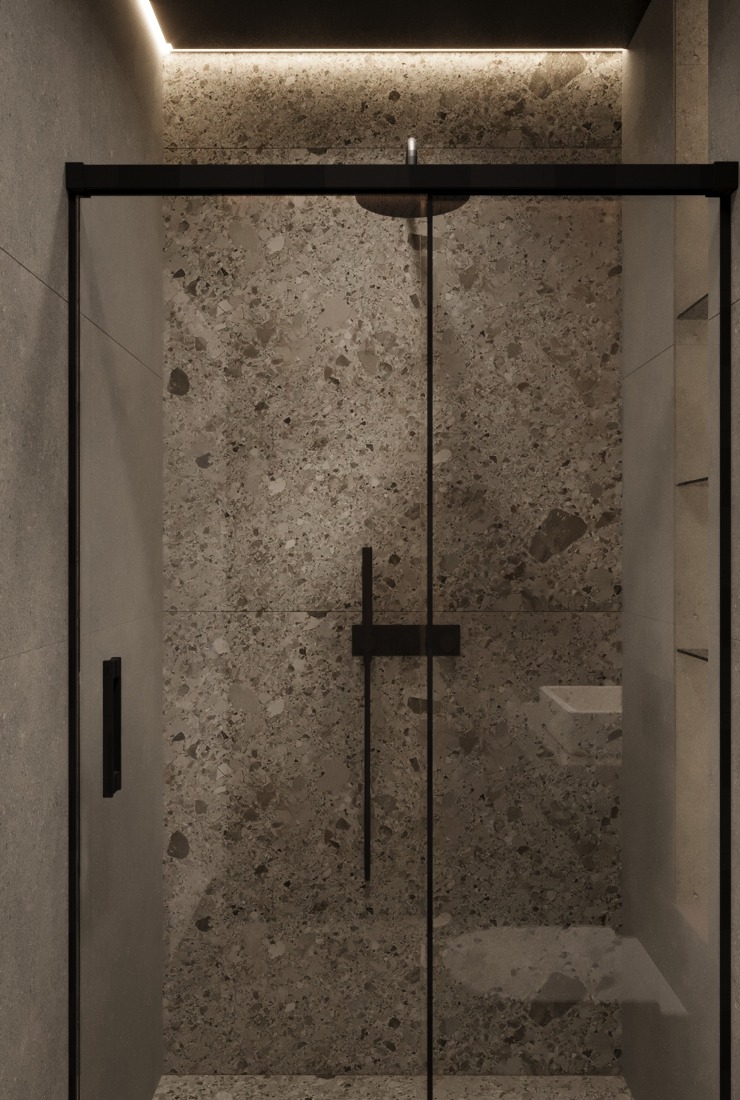 Nowoczesna kabina prysznicowa z czarnymi ramami i ścianą wykończoną płytkami imitującymi lastryko, oświetlona subtelnym światłem LED.