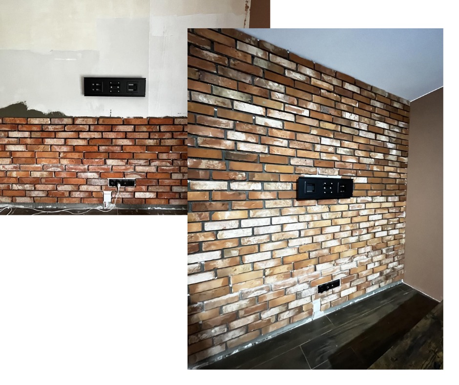 Częściowo wykończona ściana z cegły klinkierowej z zamontowanym panelem elektrycznym; widoczna instalacja elektryczna w trakcie prac.