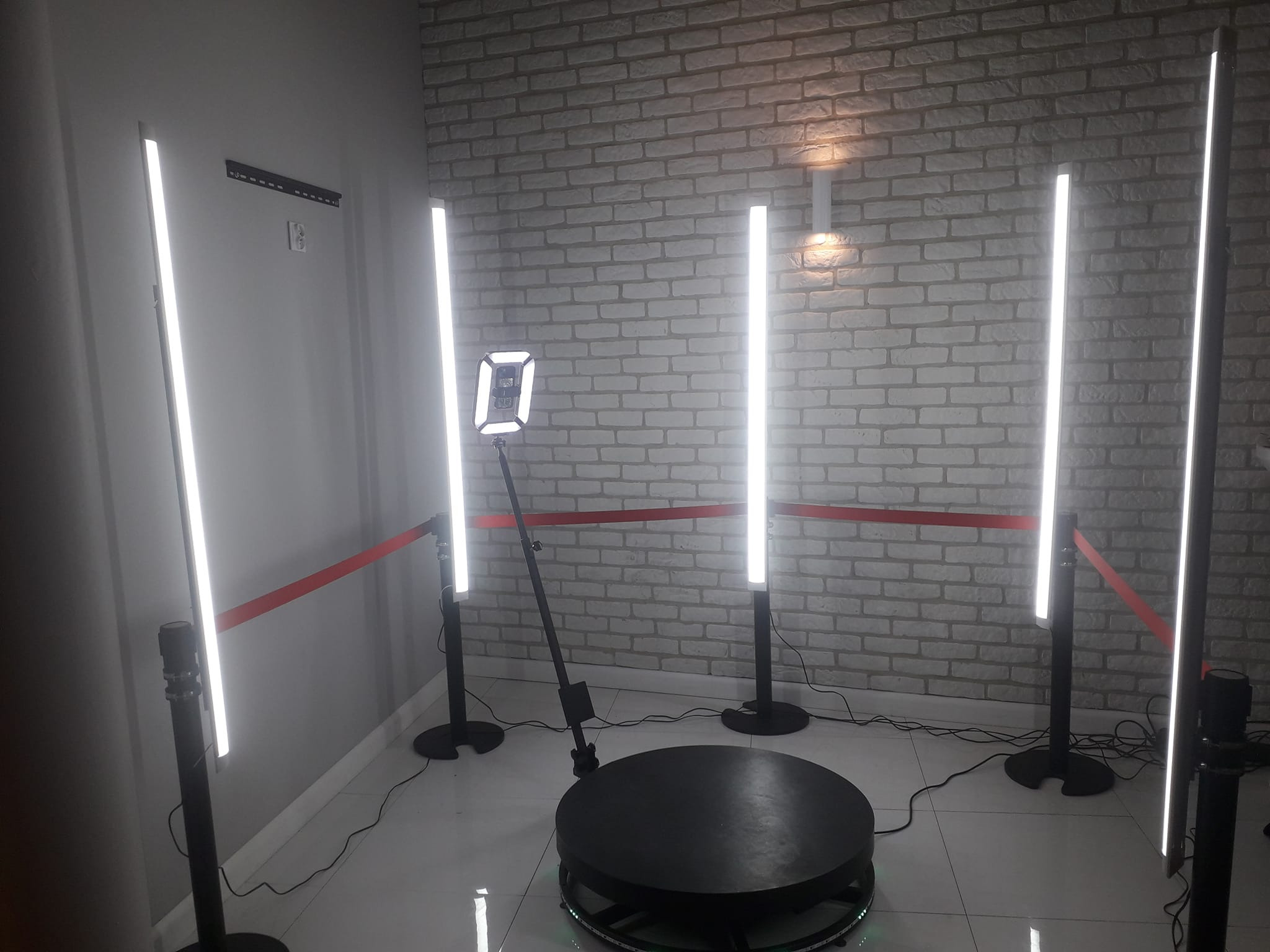 Profesjonalnie przygotowana fotobudka 360 w Żarach, otoczona ledowymi lampami i barierką z czerwoną taśmą, gotowa do użycia na imprezie.
