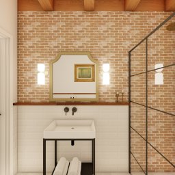 MG Interior Art Marta Godun - Wizualizacja łazienki w stylu loftowym z ceglaną ścianą, kabiną prysznicową ze złotym zestawem natryskowym, umywalką na metalowym stelażu i ozdobnym lustrem.