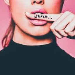 Kobieta z palcem wskazującym na ustach, na palcu napis 'Shhh...', r&oacute;żowe tło.