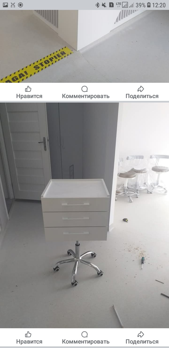 Mobilna, biała szafka z trzema szufladami na kółkach, na jasnej podłodze. W tle białe drzwi i szafa w zabudowie. Widoczne narzędzia montażowe na podłodze.