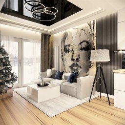NAJ House Anna Najdek - Nowoczesny salon z sofą narożną, abstrakcyjnym portretem na ścianie, choinką przy oknie i czarnym, podwieszanym sufitem z okrągłymi lampami.