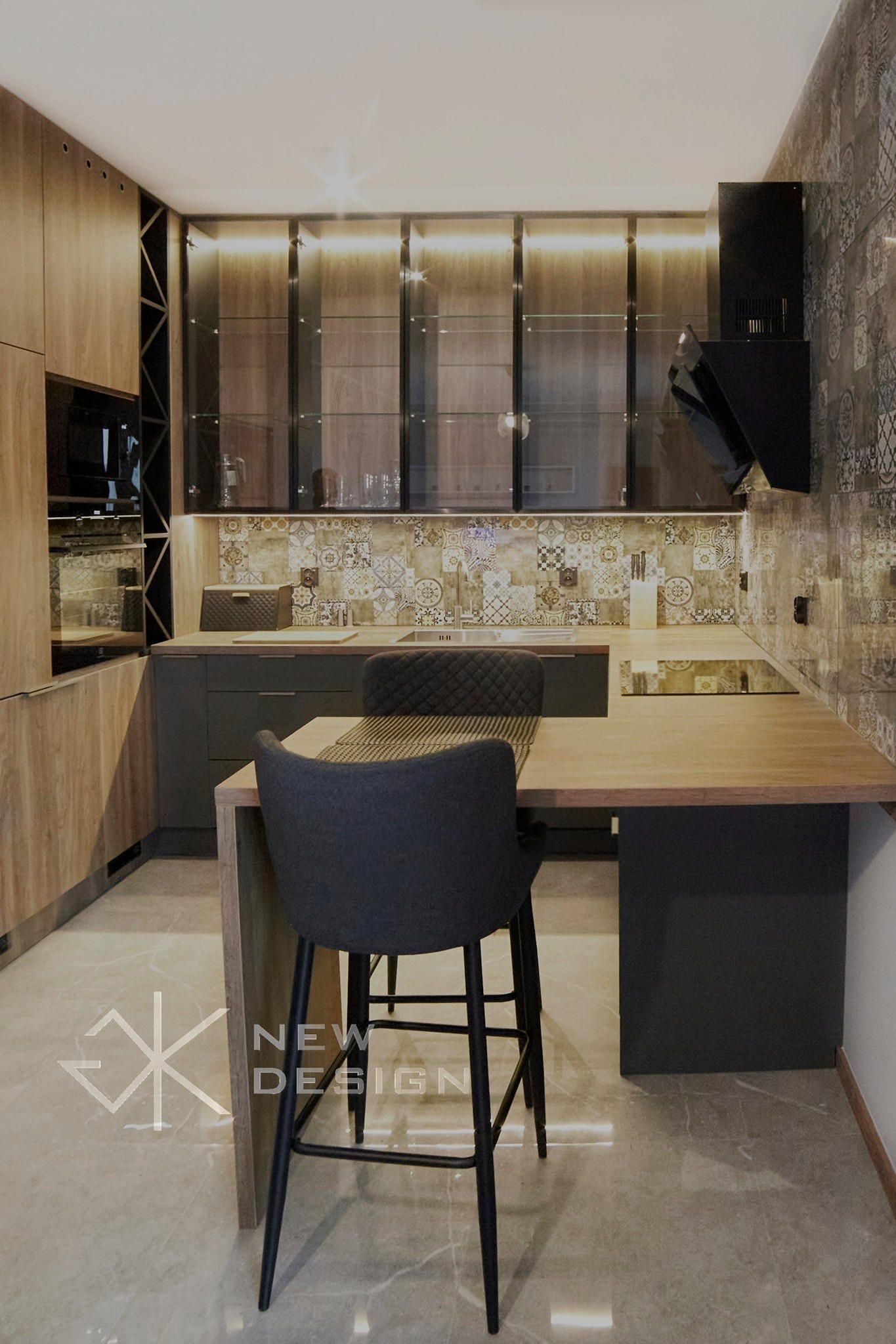 Nowoczesna kuchnia z drewnianymi frontami szafek i czarnymi akcentami, oświetleniem LED pod szafkami wiszącymi i wyspą z wysokim krzesłem barowym. Na podłodze marmurowe płytki z delikatnym logo...