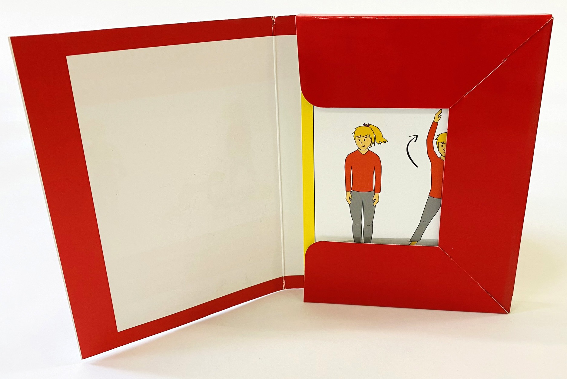 Otwarty, czerwony folder z ilustracjami postaci wykonujących ćwiczenia, widoczne elementy instrukcji.