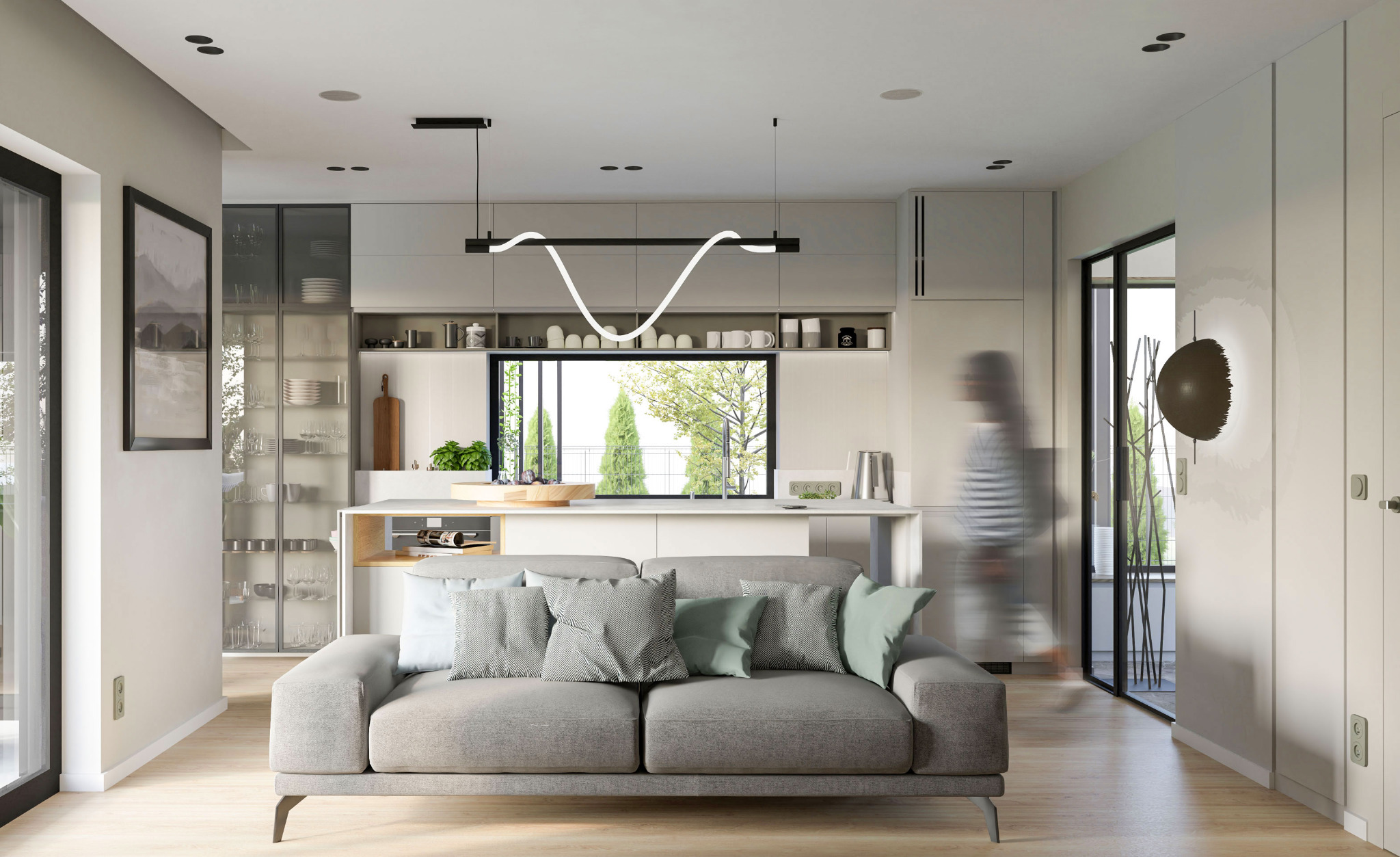 Jasne wnętrze mieszkania z otwartą kuchnią, szarą sofą z dekoracyjnymi poduszkami, nowoczesną lampą nad wyspą kuchenną i przeszkloną witryną z zastawą.