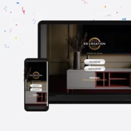Ekran laptopa i smartfona wyświetlające stronę internetową firmy meblarskiej KD Creation z logo, hasłem 'meble na miarę' oraz odnośnikami do Facebooka i Instagrama, na tle confetti.