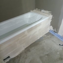 RemPejs - Wanna obudowana płytami, widoczna fuga i niedokończone prace wykończeniowe w łazience.