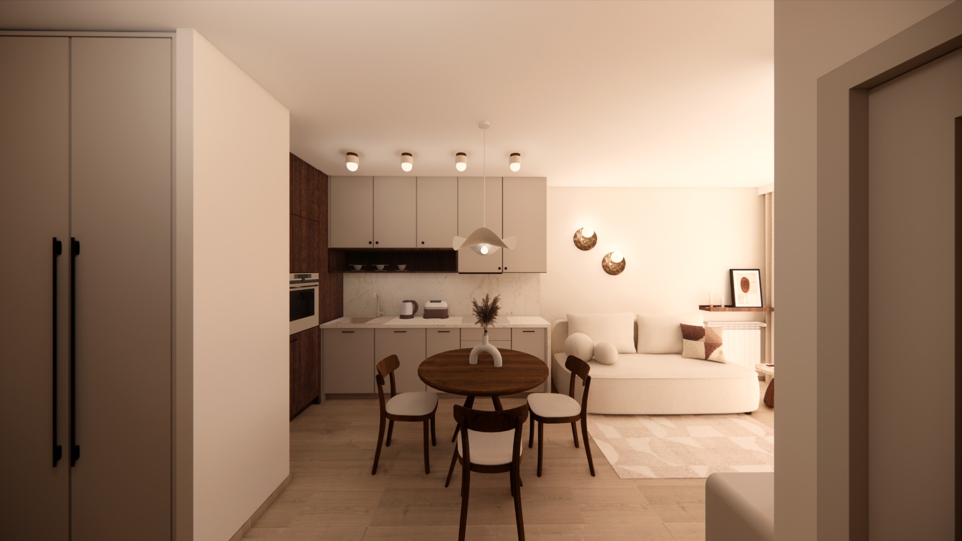 Wnętrze mieszkania: kuchnia z jadalnią i salonem w neutralnej kolorystyce. Okrągły stół z krzesłami, sofa z poduszkami, zabudowa kuchenna z oświetleniem punktowym.
