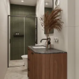 Nowoczesna łazienka z kabiną prysznicową i umywalką na szafce z drewnianym fornirem, akcentem w postaci trawy pampasowej i zielonych płytek.