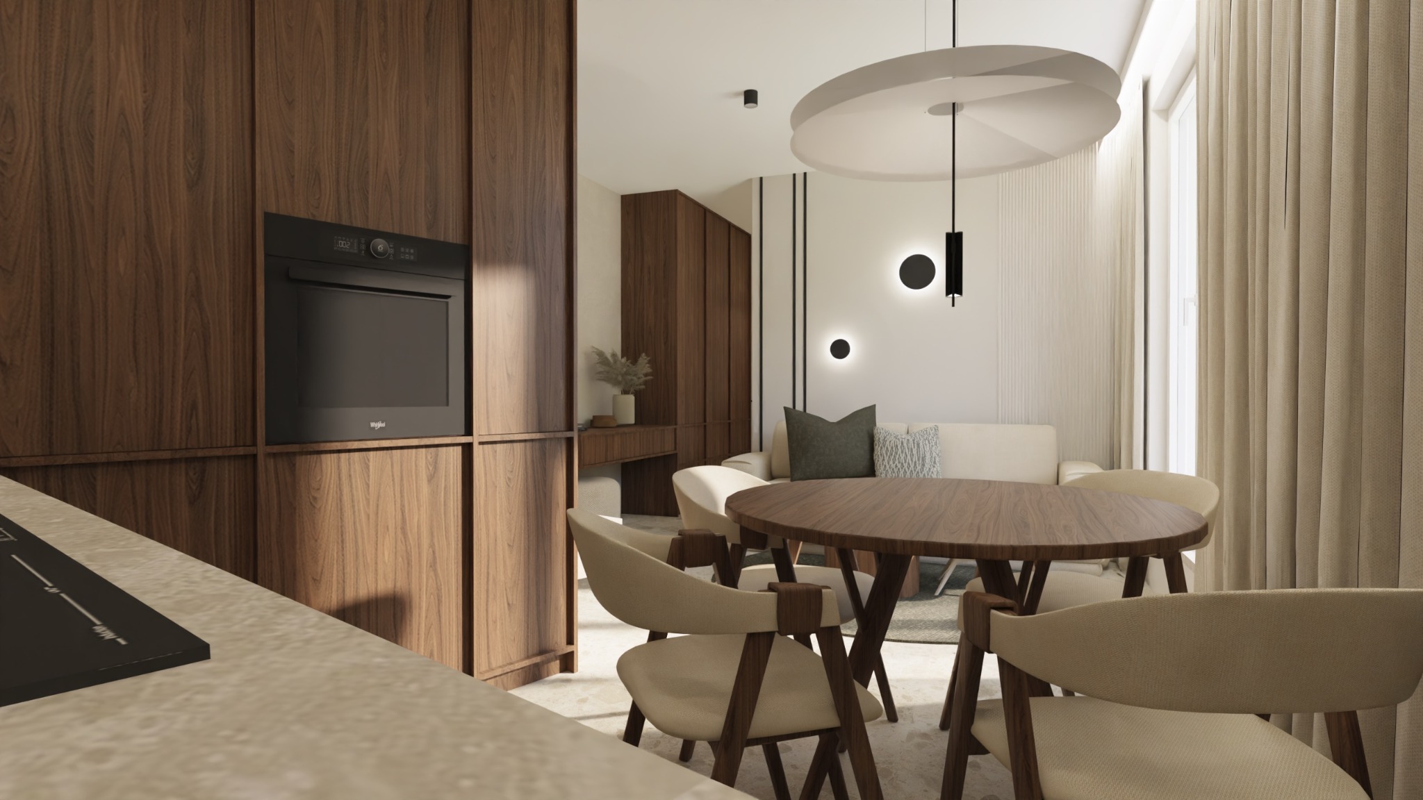 Wnętrze mieszkania: drewniana zabudowa kuchenna z piekarnikiem Whirlpool, okrągły stół z krzesłami w odcieniach beżu, sofa w tle i designerska lampa sufitowa.