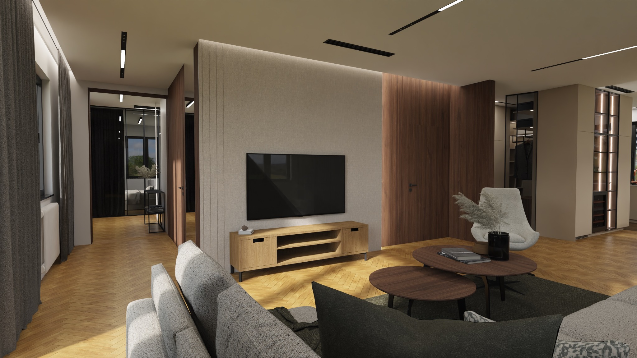 Nowoczesny salon z parkietem w jodełkę, szarą sofą, drewnianym stolikiem kawowym, szafką RTV i telewizorem na ścianie. W tle widoczny przeszklony pokój z łóżkiem i garderoba z podświetlanymi półkami.