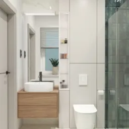 Nowoczesna łazienka z wiszącą szafką z umywalką nablatową, toaletą podwieszaną i kabiną prysznicową z zielonymi płytkami.