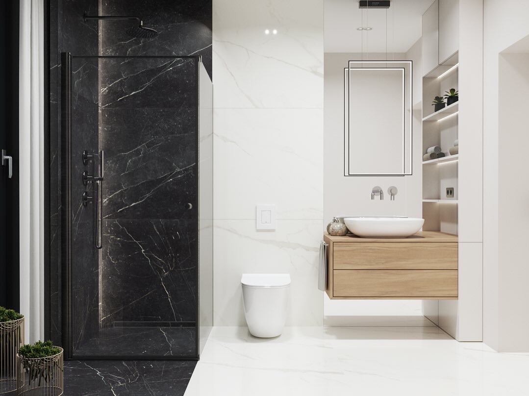Elegancka łazienka w bieli i czerni z marmurowym prysznicem typu walk-in, wiszącą szafką z umywalką nablatową i podświetlanym lustrem.