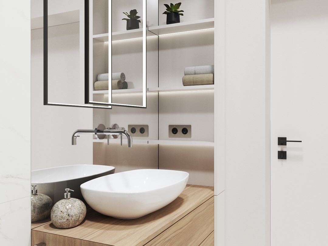 Nowoczesna łazienka z dwiema umywalkami nablatowymi o owalnym kształcie, baterią ścienną, lustrem z podświetleniem LED i półkami z roślinami doniczkowymi.