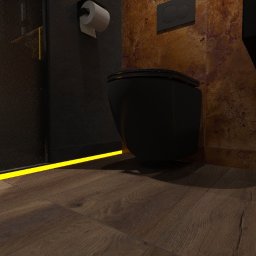 G Art design studio Aleksandra Gumoś - Nowoczesna toaleta w ciemnej tonacji z podświetleniem LED na podłodze z drewnianych paneli. Minimalistyczny design i ciepłe światło tworzą elegancką atmosferę.