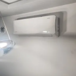 Biały klimatyzator marki Imoto Series zamontowany na ścianie w pomieszczeniu z widocznym fragmentem lampy i okrągłym czujnikiem temperatury.