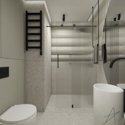 Adelina Interiors - Minimalistyczna łazienka w odcieniach szarości z kabiną prysznicową z ryflowanego szkła, czarnym grzejnikiem drabinkowym i umywalką nablatową z czarną armaturą.
