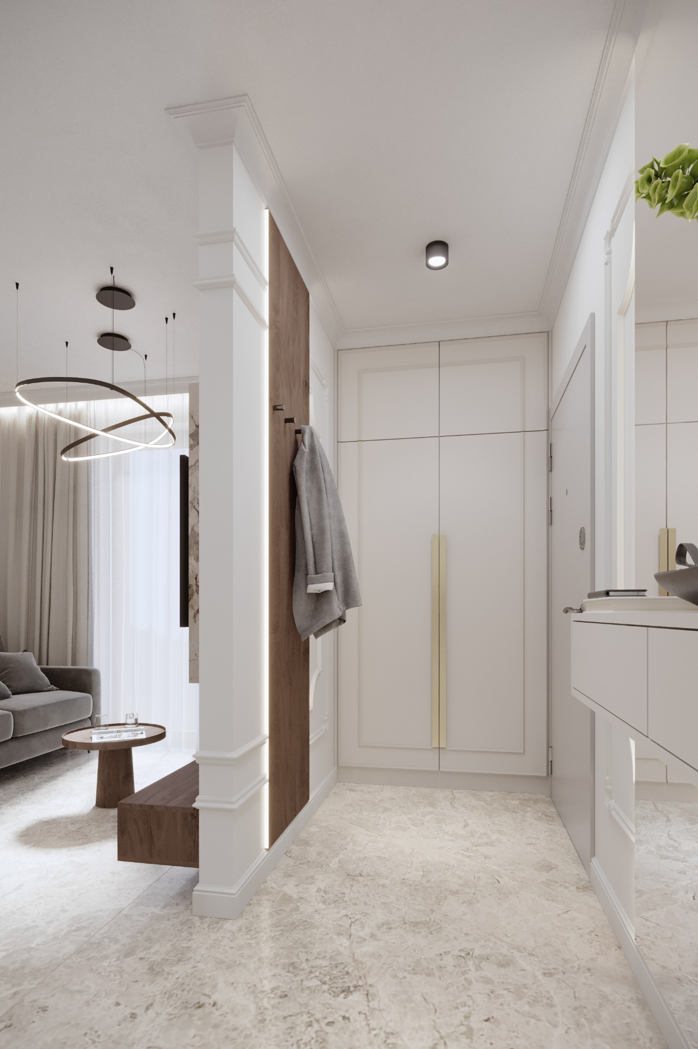 Elegancki przedpokój z szafą w zabudowie, drewnianym panelem z wieszakami i marmurową podłogą. Widoczny fragment salonu z sofą i stolikiem kawowym.