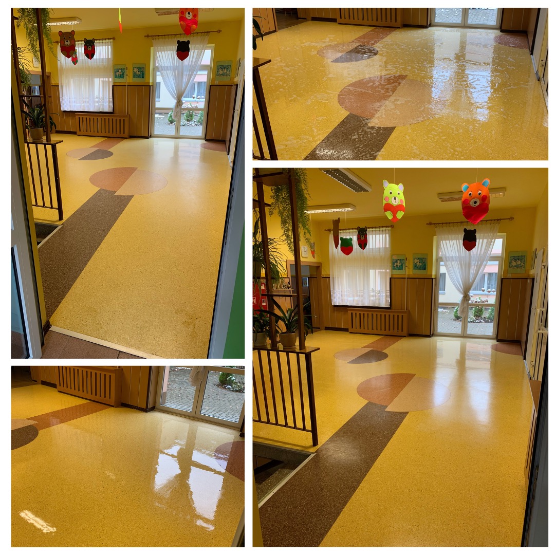 Żółta, błyszcząca podłoga z wzorami w przedszkolu lub szkole po umyciu, widoczne odbicia światła i okien, dekoracje wiszące pod sufitem.