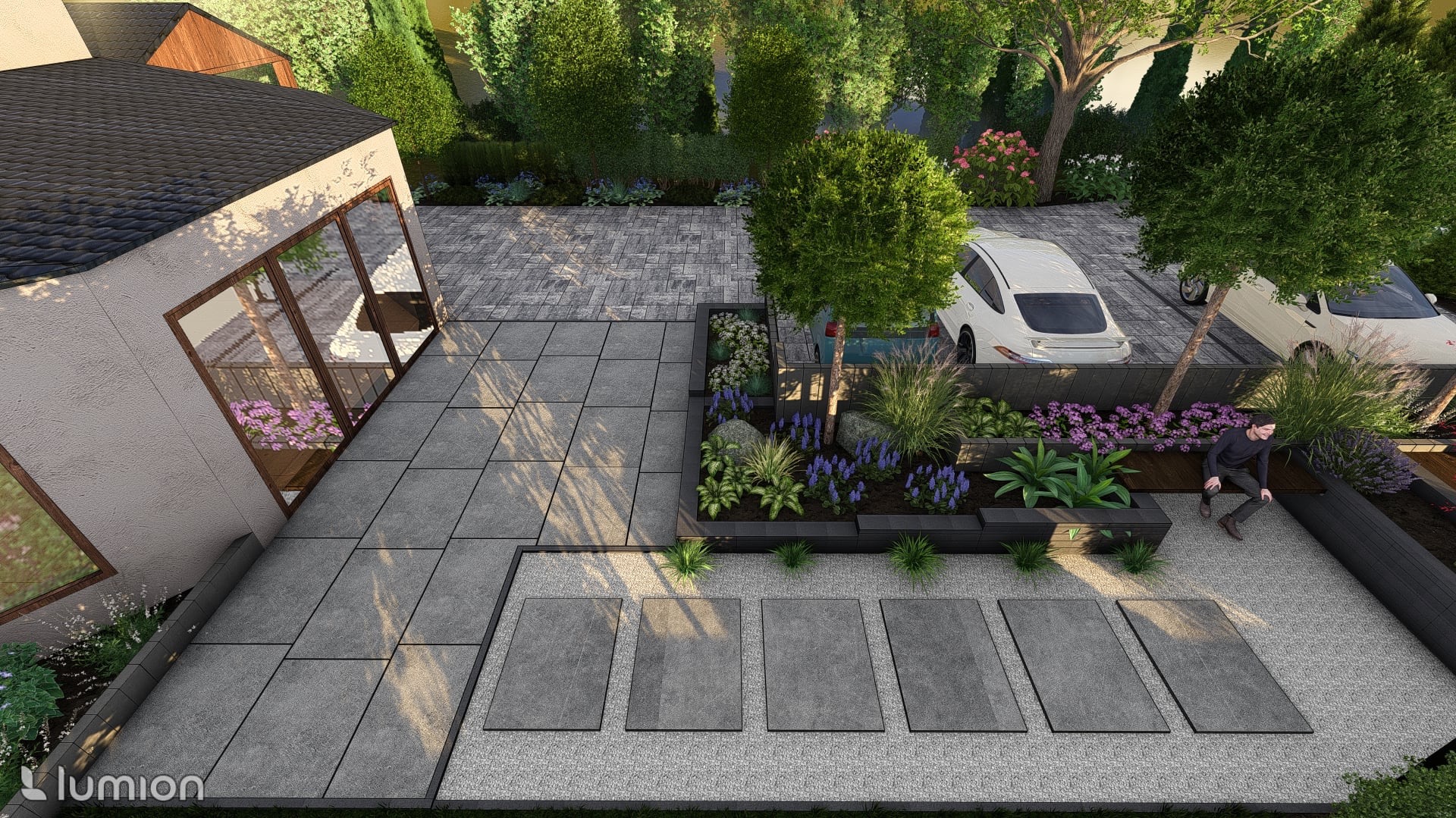 Wizualizacja ogrodu z nowoczesnym tarasem z szarych płyt, rabatami kwiatowymi w czarnych obrzeżach i miejscem parkingowym z kostki. Siedząca postać dodaje skali.