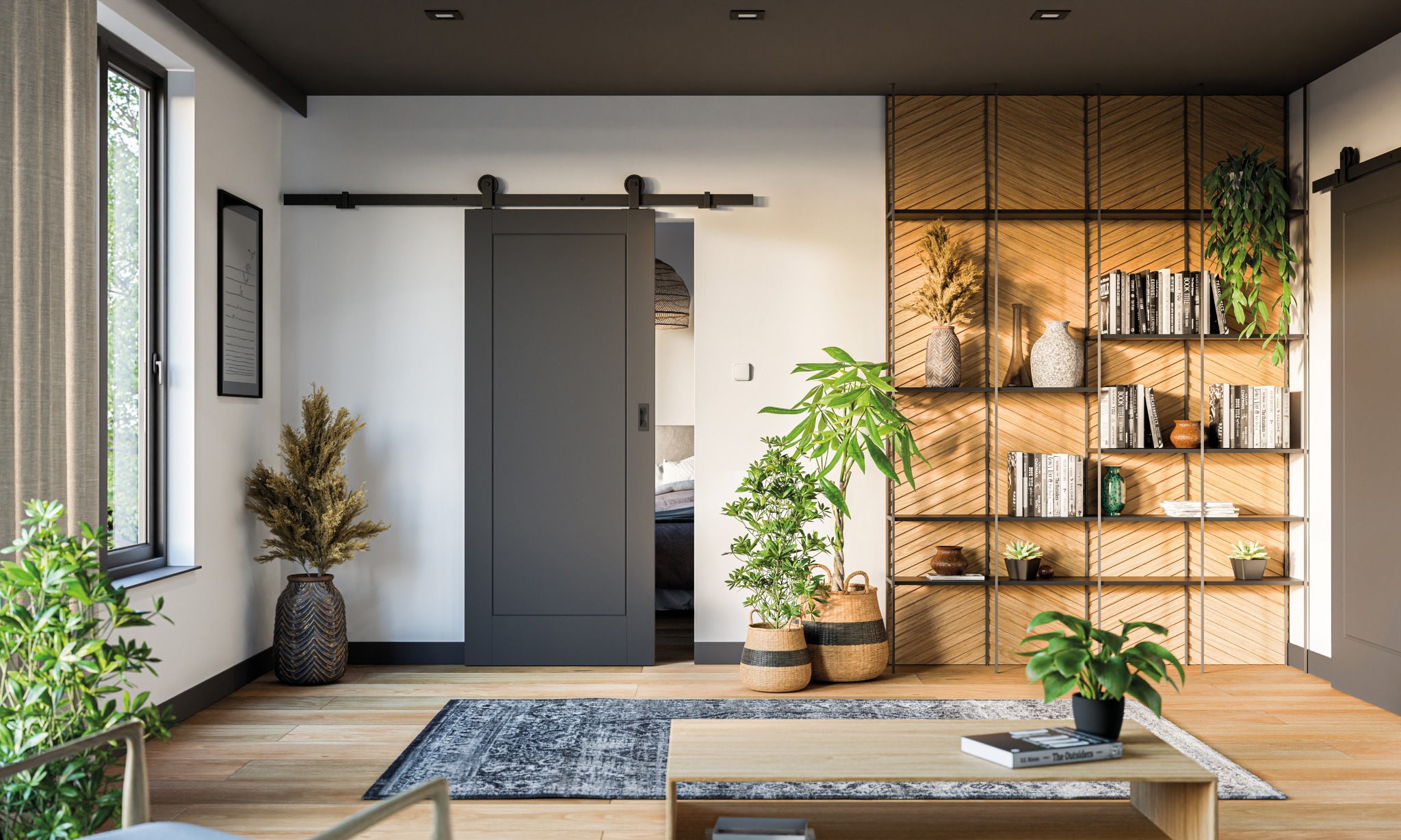 Nowoczesne wnętrze z szarą przesuwną drzwią na czarnej szynie, drewnianą podłogą, dywanem w stylu vintage i regałem z książkami i roślinami.
