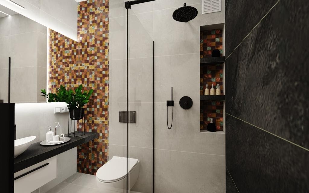 Nowoczesna łazienka z kabiną prysznicową typu walk-in, mozaiką w odcieniach brązu i złota, czarną armaturą oraz roślinami doniczkowymi na blacie umywalki.