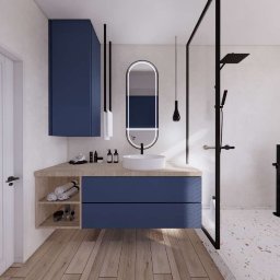 PPKstudio - Nowoczesna łazienka z granatowymi szafkami, okrągłą umywalką nablatową, podświetlanym lustrem w czarnej ramie, kabiną prysznicową typu walk-in z czarnymi elementami i drewnianą podłogą.
