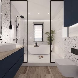 PPKstudio - Wizualizacja nowoczesnej łazienki z wolnostojącą wanną, umywalką nablatową na drewnianym blacie, toaletą podwieszaną i ścianą wykończoną mozaiką lastryko, oddzielona szklaną ścianką.