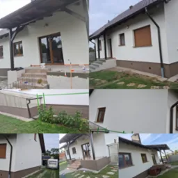 Wykończona elewacja domu jednorodzinnego, z widocznym fragmentem tarasu w trakcie układania płytek, jasna elewacja, brązowe okna i orynnowanie.