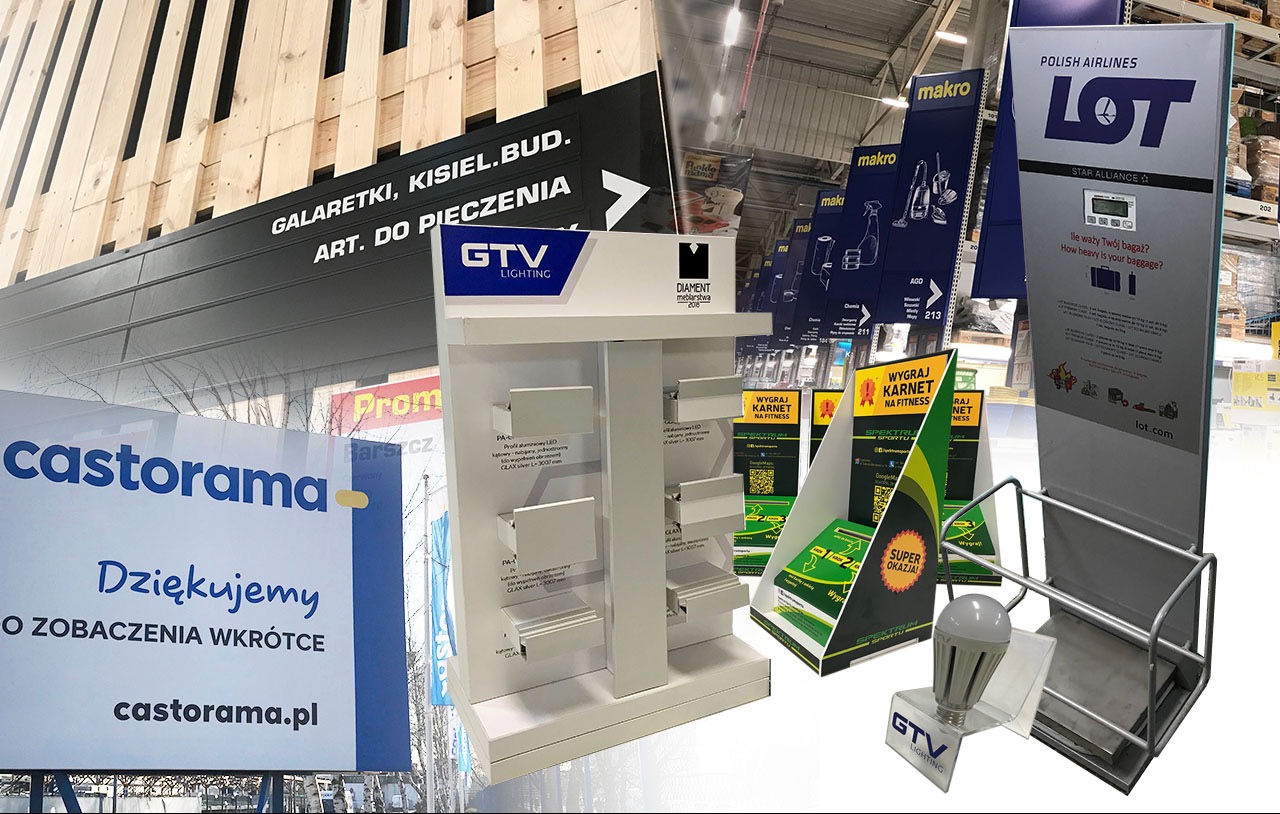 Zestaw różnorodnych ekspozytorów reklamowych w przestrzeni handlowej, w tym stojaki z logo Castorama, LOT, Makro, GTV Lighting, prezentujące produkty i informacje promocyjne.