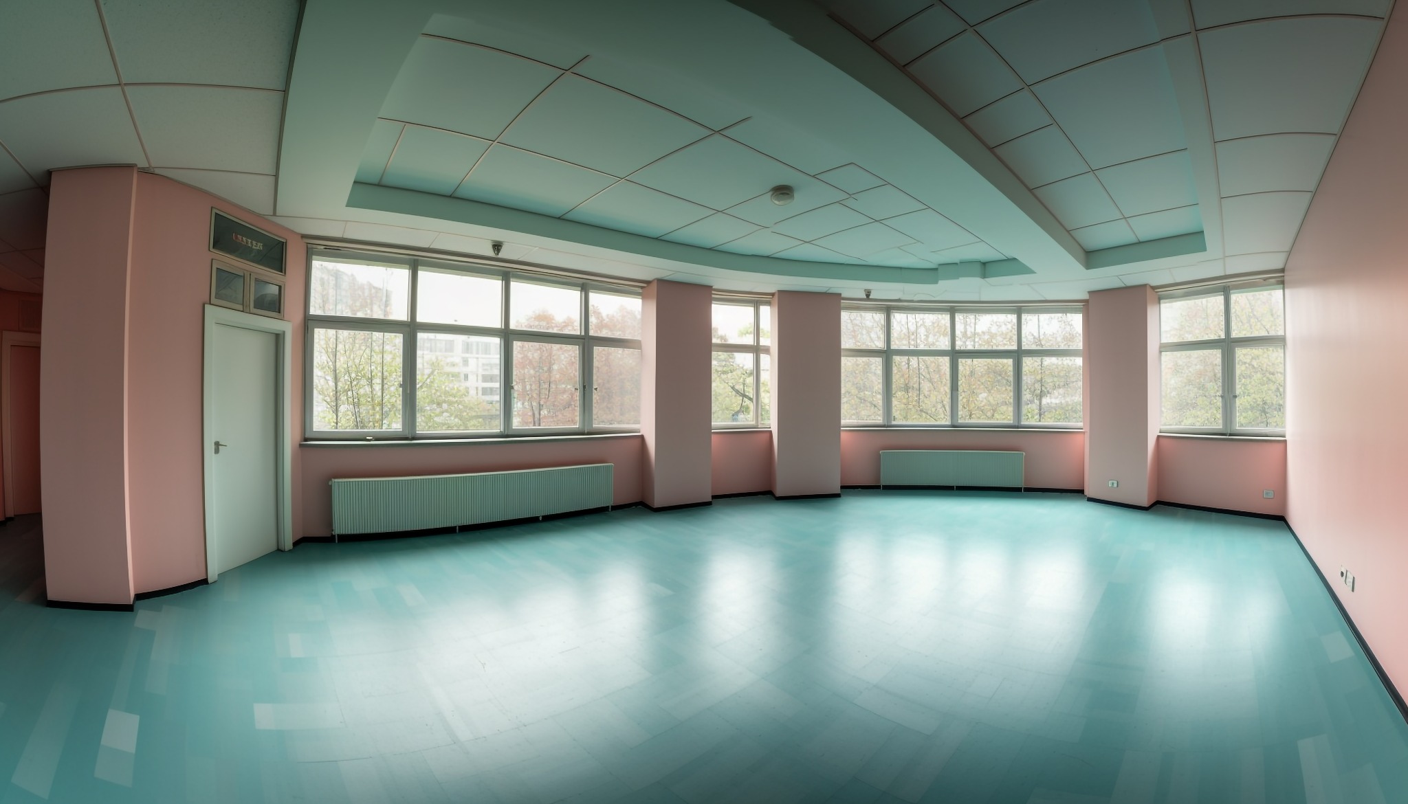 Puste, jasne biuro z turkusową podłogą, różowymi ścianami i dużymi oknami z widokiem na drzewa.