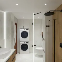 Nowoczesna łazienka z pralką i suszarką w zabudowie, umywalką nablatową i czarną armaturą, drewnopodobne panele na ścianie prysznica.