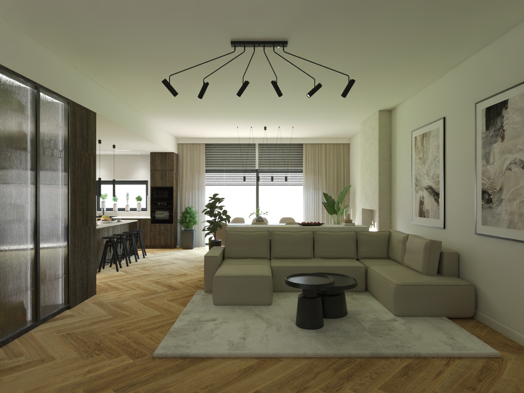 Przestronny salon z beżową sofą narożną, dywanem i parkietem w jodełkę. Widoczna kuchnia z wyspą i czarnymi hokerami. Nad sofą designerska lampa sufitowa.