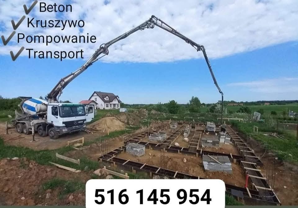 Betonomieszarka z wysięgnikiem pompuje beton do szalunków fundamentowych na placu budowy domu jednorodzinnego z widocznym w tle domem.